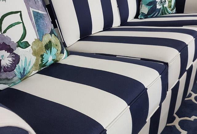 Upholstered couch with a striped pattern, highlighting custom furniture and superior design